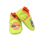 Chaussons bébé en cuir souple vert anis motif pirate et âne, vue en biais mettant en valeur les appliqués et les finitions orange.