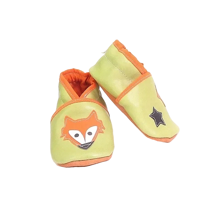 Chaussons en cuir souple artisanaux vert clair pour bébé, vue en angle, avec renard orange et étoile noire.